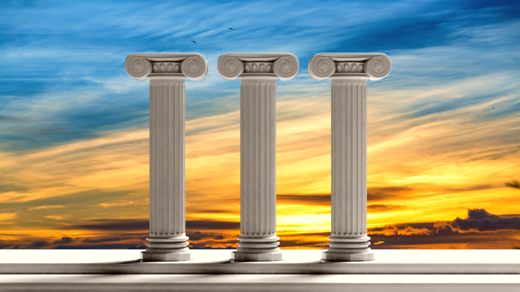 three pillars against the backdrop of a sunset or sunrise